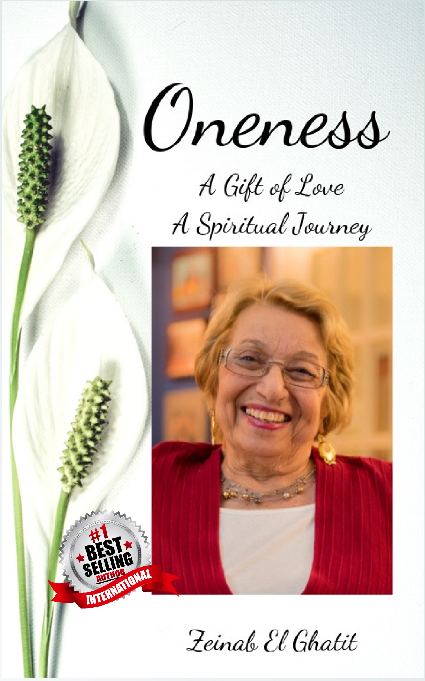 Two white flowers are along the left-hand edge of the cover. At the top in a cursive font is ONENESS: A GIFT OF LOVE A SPIRITUAL JOURNEY. Below that is a headshot of Zeinab with a big smile. Below her image in cursive font is ZEINAB EL GHATIT. Next to her image, overlayed over the flowers, is a #1 Best Selling Author International badge.
